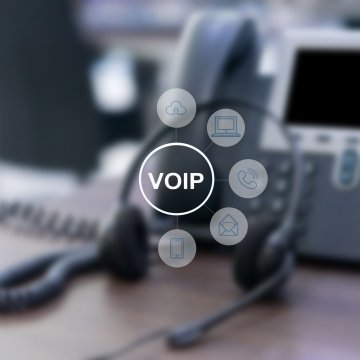 axvoice voip service overview voip voip symbols icons and voip phone on desk office blurred in the background